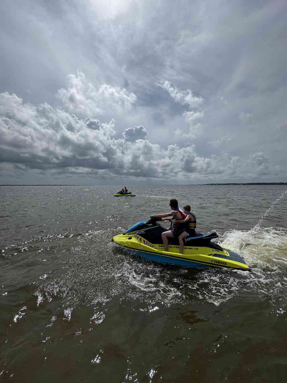 Father and son riding a WaveRunner